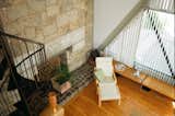 The bedroom, accessed via a spiral staircase, overlooks the living room. Also on the second level is a full bath and an outdoor terrace.