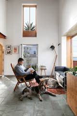 Derek and the dogs bask in the warm sunlight by one of the bay windows. Derek and Jean are keen supporters of local artists, and they have decorated the space with pieces by Banele Khoza, Conrad Botes, and Jeanne Gaigher. The living room lamp is by Douglas’s husband and firm partner, Jan, while the bentwood armchair and side tables are vintage finds.