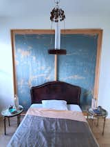 The bedroom, featuring the antique bed and the custom wall covering behind it.&nbsp;