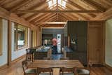 “One of the most important aspects of this house is the timber roof,” says architect Gabe Hodge. “There are no interior partitions that engage with that roof—it’s free from the fireplace all the way to the other end of the house.” The effect is a continuous, unbroken canopy that amplifies the feeling of openness. The kitchen, pantry, and powder room are conceived as a block of smaller spaces within the open floor plan.