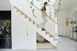 When Melanie Ryan and Todd Sussman, founders of design studio OPEN For Humans, built their home in Los Angeles’ Echo Park neighborhood, the irregularly shaped and compact lot meant that the floor plan had to be ultra-creative. Underneath a perforated-metal banister near the kitchen, a large pantry and storage drawer offer extra space for miscellaneous items.&nbsp;