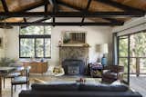 A new trapezoid window follows the angle of the roof, and large new sliding doors connect to the deck, allowing the once dark and cramped living room to feel open and inviting.
