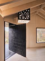 “For me, architecture is pragmatic yet joyful,” Andrew says. “The entrance cut away allows for a deep cantilevering overhang that gives shelter when it's raining, and the 1400mm-wide pivot door is pure theatrics.”