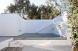 The stunning retreat is centered around a serene swimming pool with natural stone touches.

