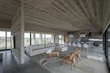 The raw concrete is complemented beautifully by warm wood details, as well as cream colored furniture.