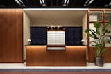The reception features terrazzo flooring and teak and walnut casework.