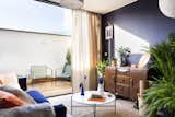 The living room in the penthouse opens to a sunlit terrace.