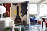 Energetic artwork replaces the typical entertainment unit found in most living rooms.  