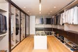 In this example, clean lines and warm textures create a thoroughly modern design. Glass doors open up the space and extend the open-floor plan.