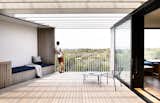 The new, protected deck frames the views, and also has a built-in bench and Electrolux grill, with a mosaic tile backsplash.
