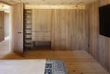 Continuing the built-in elements and panelling in the bedrooms creates visual consistency and eschews the need for additional furniture that may bring clutter. 