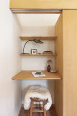 An office nook is tucked behind sliding doors in the bedroom closet.