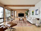 The windows were replaced with new, larger units on the lakeside wall, as well as sliding glass doors, and a slat detail added to the space between the headers and the ceiling. The back wall now has rift-sawn red oak cabinetry and paneling.