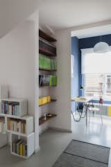 A variety of storage units—from built-in shelving to contemporary cabinets—provide plentiful space for the homeowner’s book collection.