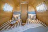 The trailer sleeps four people, two in the rear bedroom and two in the main living space.