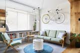 The fixed-gear bicycle hanging above the couch serves as an art piece; Chen no longer rides the bike. Le Corbusier Projecteur 165 pendant lights hang in the corner.