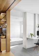 Silvery blue woven vinyl flooring continues from the living room to the bedroom. “[It] gives a contemporary reference to the traditional tatami straw flooring and brings a softness to the space,” adds Chen.