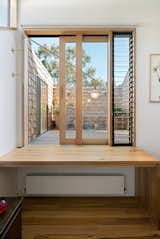 The study at the top of the stairs allows access to the first-floor deck, and it’s one of the most unique design features in the home. “The raw brass swinging arm light can be rotated off the wall and positioned as required when sitting at the desk, while the light can be swung against the wall when accessing the deck,” Rhodes says.  