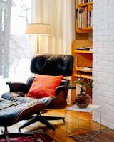A reading corner takes full advantage of floor-to-ceiling window light. 